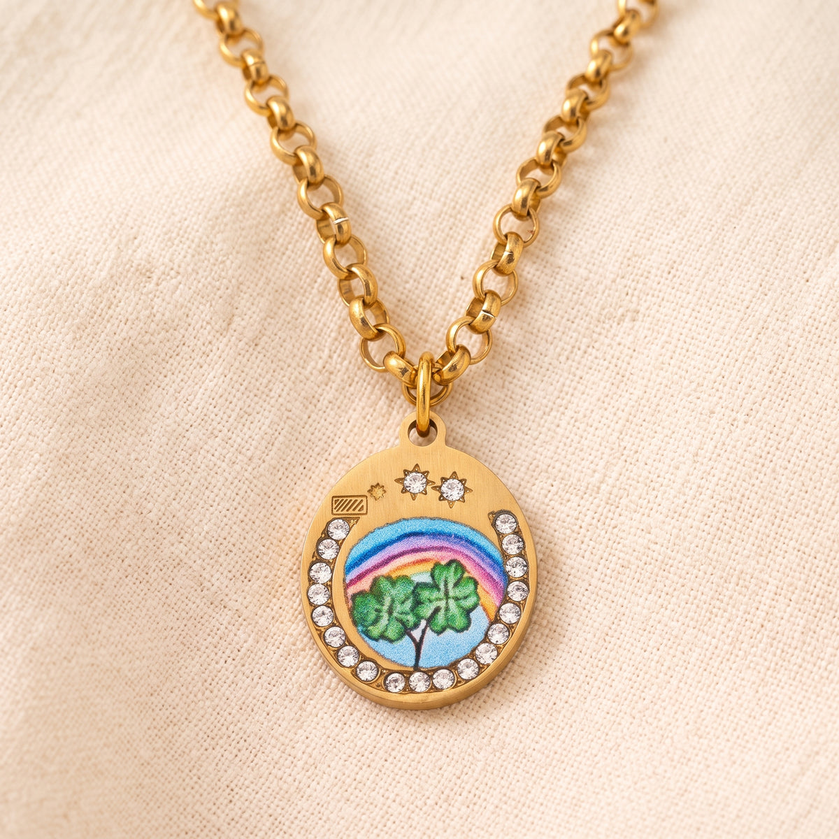 Four-Leaf Clover necklace, a small gold pendant with a painted rainbow and clover on a round-link chain