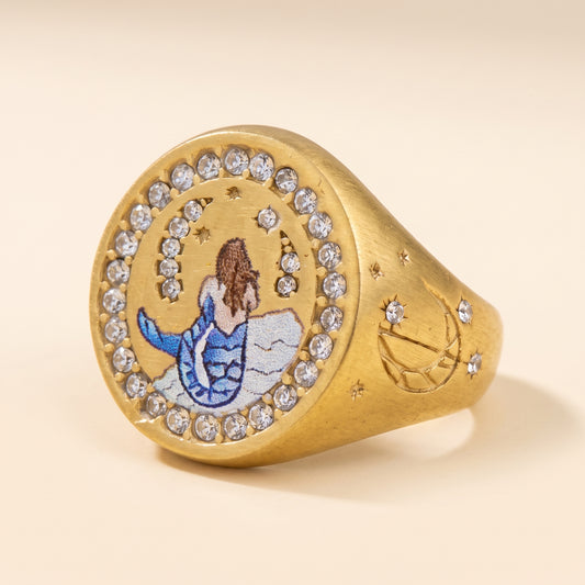Sea Siren signet ring in brushed gold, a painted mermaid framed by clear stones