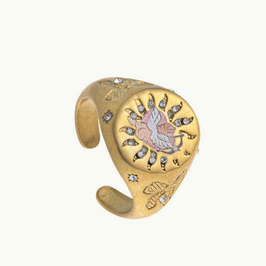 Cherub's Arrow Ring, a gold-tone signet ring with a winged enamel cherub in a sunburst of small stones