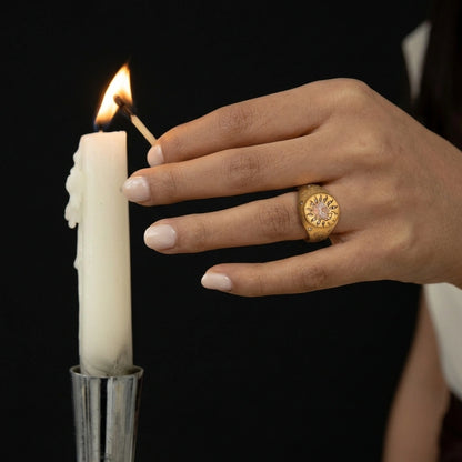 Cherub's Arrow Ring worn while lighting a candle