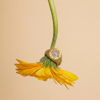 Hamsa Eye Ring slipped onto a flower stem