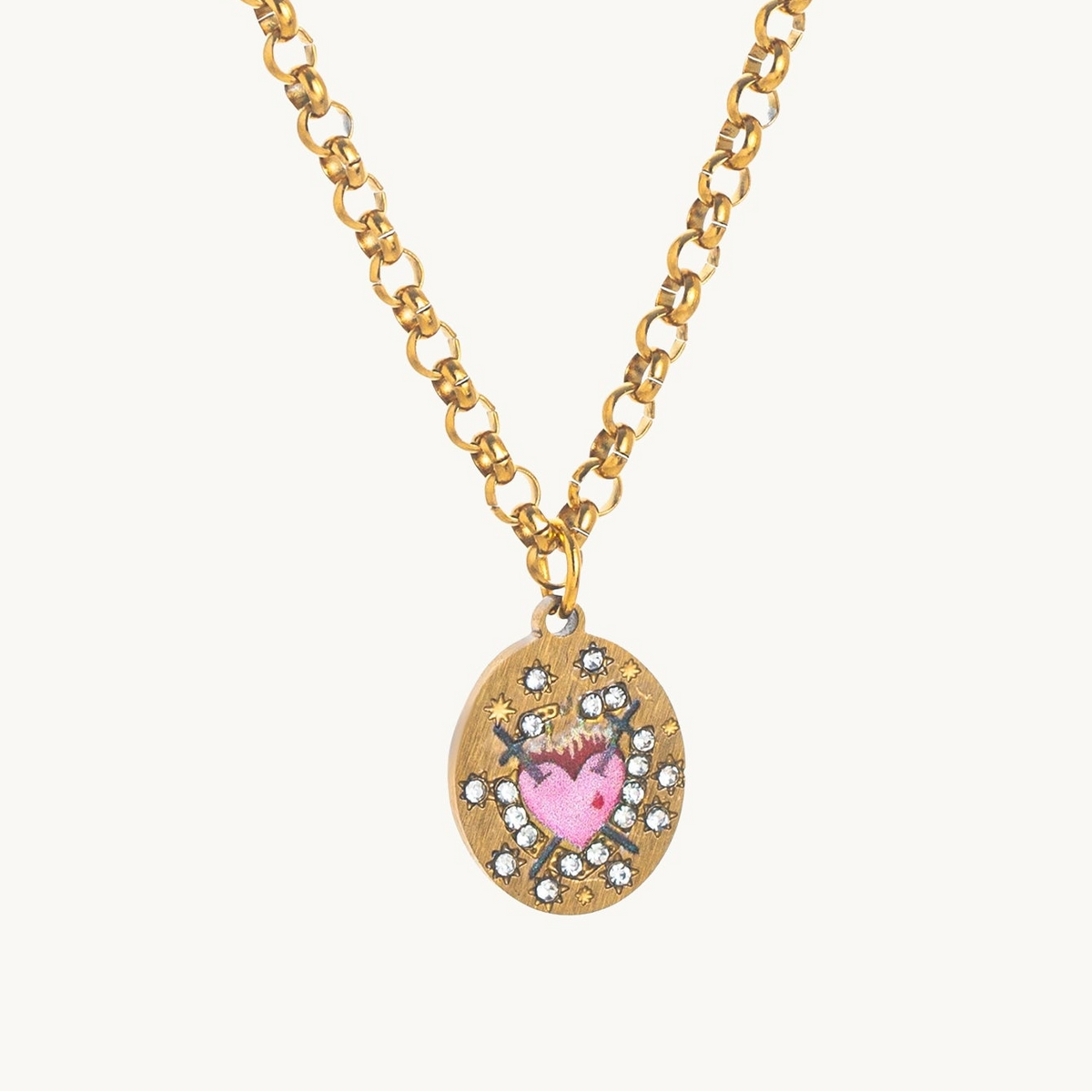 Sacred Heart Necklace, an oval gold-tone pendant with a flaming enamel sacred heart