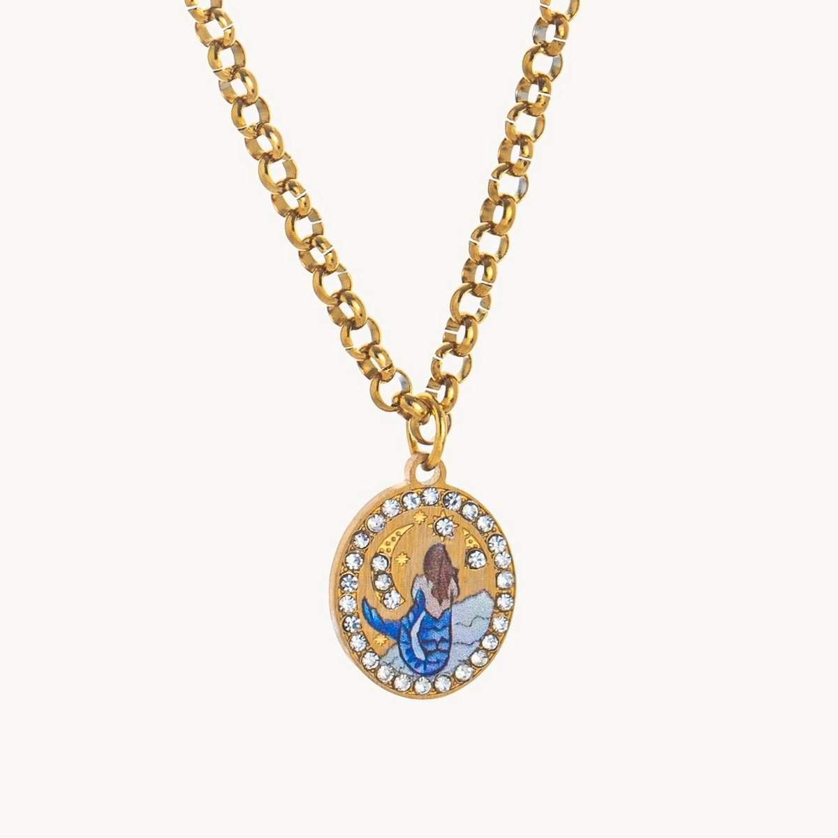 Sea Siren Necklace, an oval gold-tone pendant with an enamel mermaid under a crescent moon