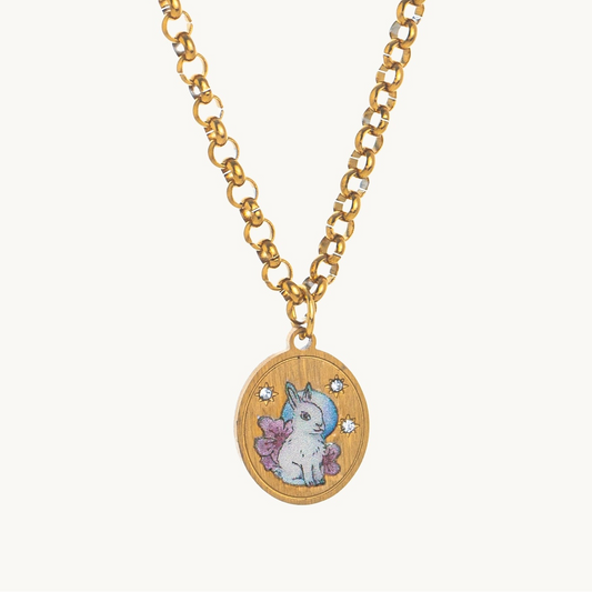 Moon Rabbit Necklace, an oval gold-tone pendant with a white enamel rabbit under the moon