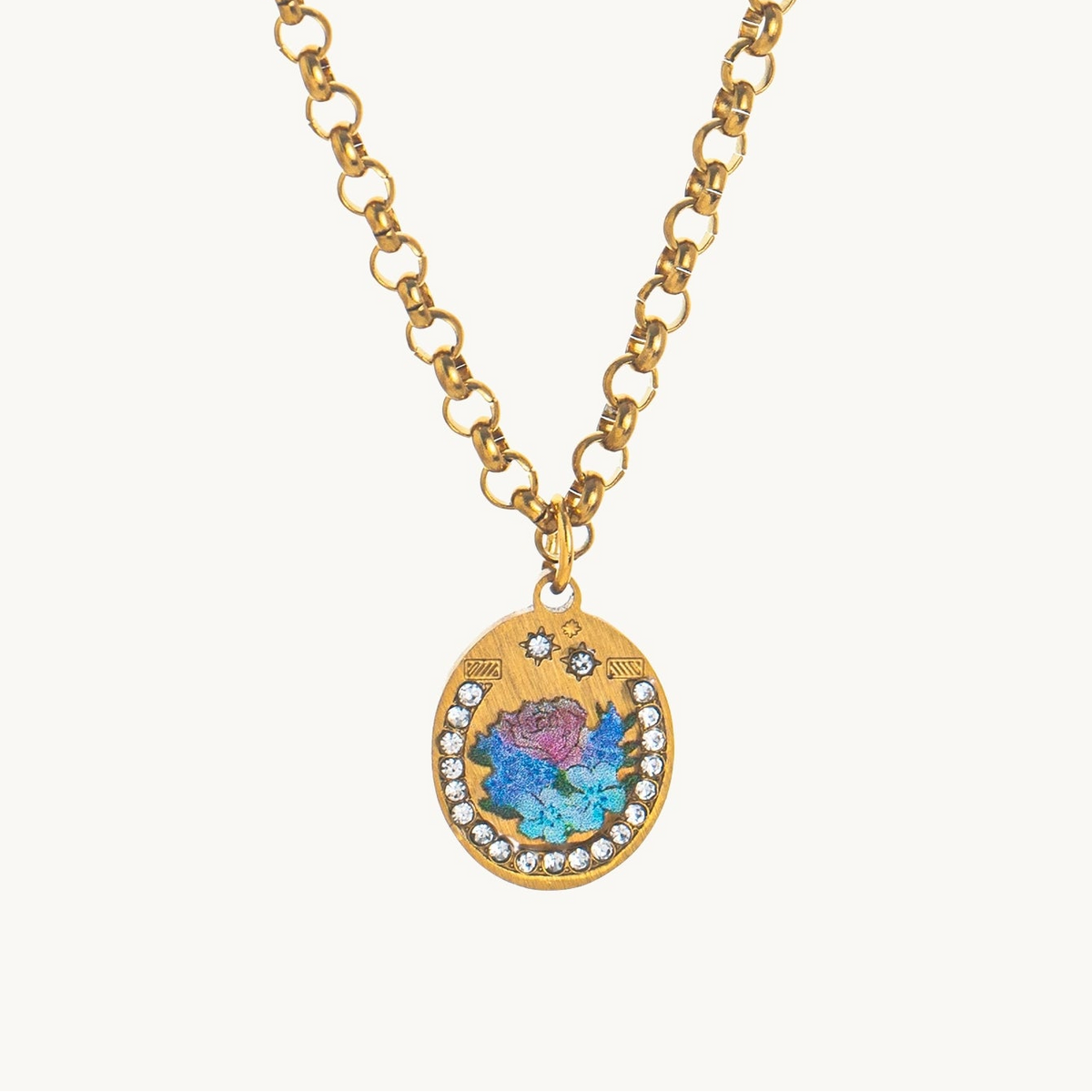 Midnight Rose Necklace, an oval gold-tone pendant with a blue and violet enamel rose