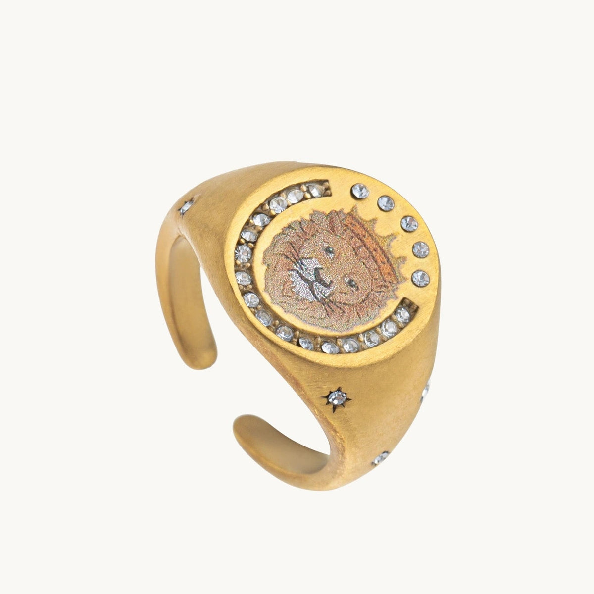 Lion Crest Ring, a gold-tone signet ring with an enamel lion's head framed by small stones